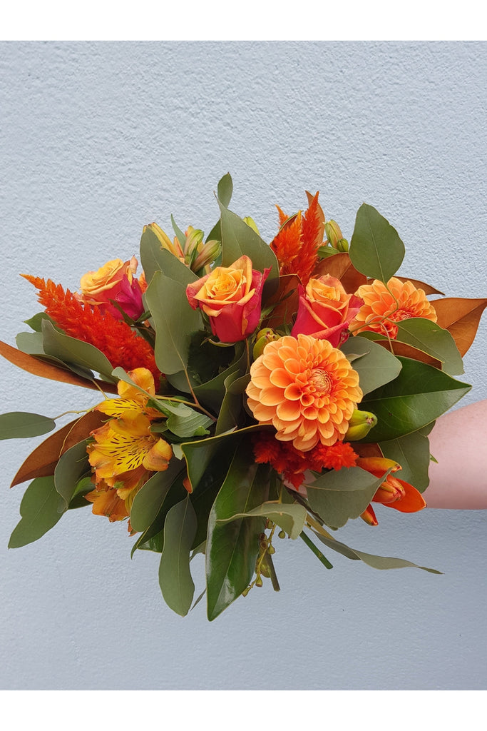 A Stunning mix of Autumn tones with lush foliage designed from seasonal flowers and foliage made by a Wellington Florist 