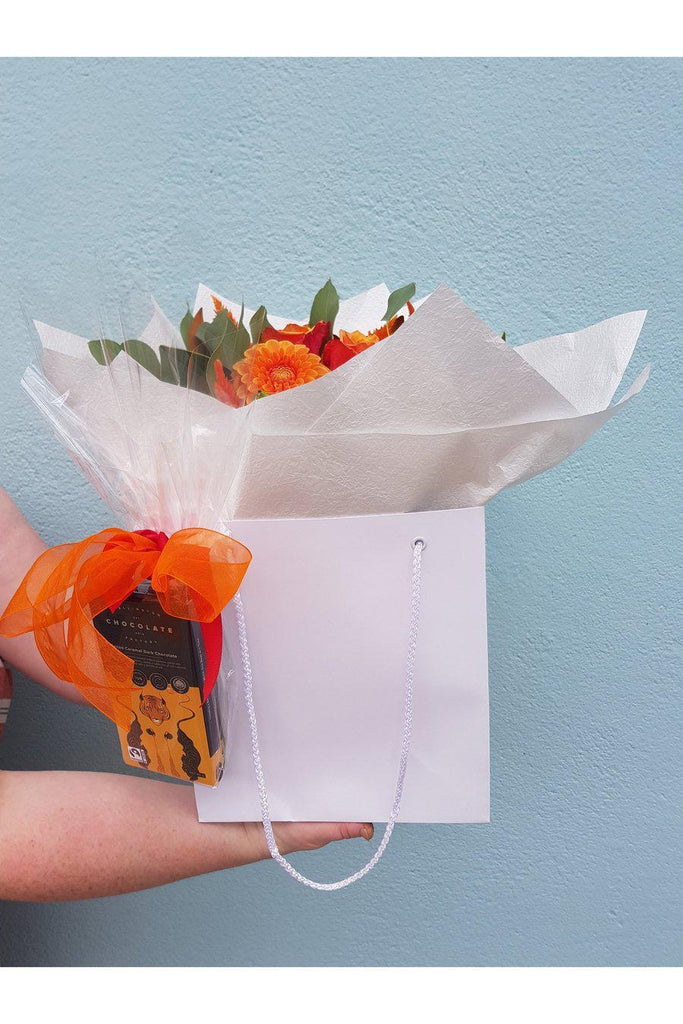 We all need a treat from time to time & this is the perfect treat. A beautiful florist choice mix of seasonal blooms with a Yummy The Wellington Chocolate factory bar beautifully attached to the wrap.